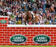8 August 2015; Greg Broderick, competing on Castlecomer Q, celebrates clearing the wall during the Land Rover Puissancein, during the Discover Ireland Dublin Horse Show 2015. RDS, Ballsbridge, Dublin. Picture credit: Matt Browne / SPORTSFILE