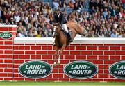 8 August 2015; Billy Twomey, competing on Ratina Kan, clears the wall during the Land Rover Puissancein at the Discover Ireland Dublin Horse Show 2015. RDS, Ballsbridge, Dublin. Picture credit: Matt Browne / SPORTSFILE