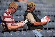 9 August 2015; Supporters read their programmes in advance of the game. Electric Ireland GAA Hurling All-Ireland Minor Championship, Semi-Final, Kilkenny v Galway. Croke Park, Dublin. Picture credit: Ray McManus / SPORTSFILE