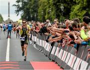 9 August 2015; Denis Chevrot, France, fought off stiff competition to take the gold medal at today’s inaugural IRONMAN 70.3 Dublin. Dublin City Council hosted the competition which saw over 2500 athletes complete a 1.2 mile swim in Scotsman’s Bay in Dun Laoghaire, before mounting their bikes to travel through Dublin and west of the city for a 56 mile cycle, to return to the Phoenix Park for the 13.1 mile half-marathon. 1,500 Irish athletes took part in today’s event and 1,000 international athletes from 40 countries travelled to Dublin to compete in the gruelling competition. Chesterfield Avenue, Phoenix Park, Dublin. Picture credit: David Maher / SPORTSFILE