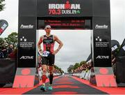9 August 2015; Kevin Thornton, Ireland, finishes third at today’s inaugural IRONMAN 70.3 Dublin. Dublin City Council hosted the competition which saw over 2500 athletes complete a 1.2 mile swim in Scotsman’s Bay in Dun Laoghaire, before mounting their bikes to travel through Dublin and west of the city for a 56 mile cycle, to return to the Phoenix Park for the 13.1 mile half-marathon.    1,500 Irish athletes took part in today’s event and 1,000 international athletes from 40 countries travelled to Dublin to compete in the gruelling competition. Chesterfield Avenue, Phoenix Park, Dublin. Picture credit: David Maher / SPORTSFILE