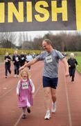 25 December 2008; Five-year-old Rachael Gillmor and her dad Stephen from Booterstown, Dublin, after 'competing' in one of the many Goal Miles at the athletics track in UCD, Belfield, Dublin. This year the event took place at 72 locations around Ireland. Annual Goal Mile, Belfield, University College, Dublin. Picture credit: Ray McManus / SPORTSFILE