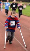 25 December 2008; Eight-year-old David Gallagher, from Mount Merrion, Dublin, makes his way down the home straight during one of the many Goal Miles at the athletics track in UCD, Belfield, Dublin. This year the event took place at 72 locations around Ireland. Annual Goal Mile, Belfield, University College, Dublin. Picture credit: Ray McManus / SPORTSFILE