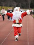 25 December 2008; Santa makes his way down the home straight after 'competing' in one of the many Goal Miles at the athletics track in UCD, Belfield, Dublin. This year the event took place at 72 locations around Ireland. Annual Goal Mile, Belfield, University College, Dublin. Picture credit: Ray McManus / SPORTSFILE