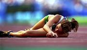 27 September 2000; Breda Dennehy Willis of Ireland lies on the track following the Women's 10,000m heat during day 13 of the Sydney Olympics in Sydney, Australia. Photo by Brendan Moran/Sportsfile