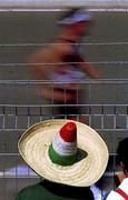29 September 2000; A Mexican supporter wearing a sombrero watches the men's 50km walking race during day 15 of the 2000 Sydney Olympics in Sydney, Australia. Photo by Brendan Moran/Sportsfile