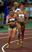 29 September 2000; Martina McCarthy, left, of Ireland receives the baton from team-mate Karen Shinkins to start the second leg of the women's 4x400m heats during day 15 of the 2000 Sydney Olympics in Sydney, Australia. Photo by Brendan Moran/Sportsfile