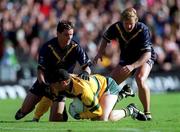 8 October 2000; Cormac Sullivan of Ireland in action against Adam Yze, left, and Nathan Brown of Australia during the International Rules Series First Test match between Ireland and Australia at Croke Park in Dublin. Photo by Ray McManus/Sportsfile *** Local Caption *** 8 October 2000; Cormac Sullivan of Ireland in action against Adam Yze, left, and Nathan Brown of Australia during the International Rules Series First Test match between Ireland and Australia at Croke Park in Dublin. Photo by Ray McManus/Sportsfile