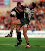 8 October 2000; Mark Ricciuto of Australia is tackled by Anthony Tohill of Ireland during the International Rules Series First Test match between Ireland and Australia at Croke Park in Dublin. Photo by Ray McManus/Sportsfile
