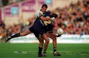 8 October 2000; Mark Ricciuto of Australia is tackled by Anthony Tohill of Ireland during the International Rules Series First Test match between Ireland and Australia at Croke Park in Dublin. Photo by Ray McManus/Sportsfile
