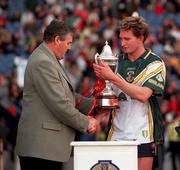 15 October 2000; GAA President Sean McCague presents the trophy to Australia captain James Hird following the International Rules Series Second Test match between Ireland and Australia at Croke Park in Dublin. Photo by Brendan Moran/Sportsfile
