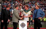 15 October 2000; GAA President Sean McCague presents the trophy to Australia captain James Hird following the International Rules Series Second Test match between Ireland and Australia at Croke Park in Dublin. Photo by Brendan Moran/Sportsfile