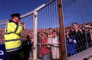 15 October 2000; A member of An Garda Siochana looks on at Hill 16 during the International Rules Series Second Test match between Ireland and Australia at Croke Park in Dublin. Photo by Brendan Moran/Sportsfile