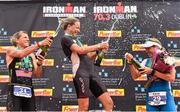 9 August 2015; Susie Cheetham, centre, Great Britain, celebrates with second place Samantha Warriner, left, New Zealand, and third place Sonja Tajisich, Germany, after fighting off stiff competition to take the gold medal at today’s inaugural IRONMAN 70.3 Dublin. Dublin City Council hosted the competition which saw over 2500 athletes complete a 1.2 mile swim in Scotsman’s Bay in Dun Laoghaire, before mounting their bikes to travel through Dublin and west of the city for a 56 mile cycle, to return to the Phoenix Park for the 13.1 mile half-marathon.    1,500 Irish athletes took part in today’s event and 1,000 international athletes from 40 countries travelled to Dublin to compete in the gruelling competition. Chesterfield Avenue, Phoenix Park, Dublin. Picture credit: David Maher / SPORTSFILE