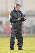 4 January 2009; Limerick manager Justin McCarthy checks his notes before the game. Waterford Crystal Cup, Limerick v University Limerick, Claughaun GAA Club, Claughaun, Limerick. Picture credit: Pat Murphy / SPORTSFILE