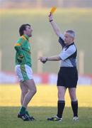 4 January 2009; Shane McAnarney, Meath, is shown a yellow card by referee Tom Quigley to be sent off and replaced by a substitute under the experimental disciplinary playing rules. O'Byrne Cup, First Round, Meath v Westmeath, Pairc Tailteann, Navan, Co. Meath. Photo by Sportsfile