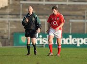 4 January 2009; Linesman Ger Lynch signals to the sideline as Cork's Eddie Burke leaves the pitch after receiving a yellow card from referee Aidan Mangan. McGrath Cup Preliminary Round, Cork v Cork Institute of Technology, Pairc Ui Rinn, Cork. Picture credit: Brendan Moran / SPORTSFILE