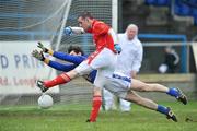 11 January 2009; Shane Lennon, Louth, scores his side's second goal despite the challange from Kevin Smith, Longford. O'Byrne Cup Quarter-Final, Longford v Louth, Pearse Park, Longford. Picture credit: David Maher / SPORTSFILE