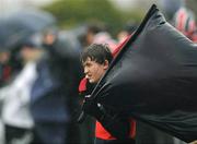 14 January 2009; A Wesley College supporter braves the bad weather during the match. Leinster Schools Vinnie Murray Senior Cup First Round - Section B, Newpark v Wesley College, Kiltiernan, Co. Dublin. Picture credit: Brian Lawless / SPORTSFILE