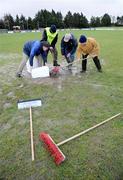 18 January 2009; Stewards try to remove the excess water from the pitch before the match. FBD League, Section A, Mayo v Roscommon, Ballyhaunis GAA Club, Ballyhaunis, Co. Mayo. Picture credit: Ray Ryan / SPORTSFILE