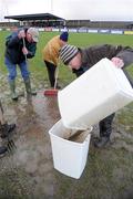 18 January 2009; President of Ballyhaunis GAA club Michael Webb, empties excess water from the pitch before the match. FBD League, Section A, Mayo v Roscommon, Ballyhaunis GAA Club, Ballyhaunis, Co. Mayo. Picture credit: Ray Ryan / SPORTSFILE