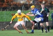 18 January 2009; Karl Stewart, Antrim, in action against Joe Phelan, Laois, under the watch of referee Dickie Murphy. Walsh Cup, Laois v Antrim, Kelly Daly Park, Rathdowney, Co. Laois. Picture credit: Brian Lawless / SPORTSFILE