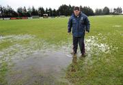 18 January 2009; Mayo manager John O'Mahony inspects the water on the pitch before the match. FBD League, Section A, Mayo v Roscommon, Ballyhaunis GAA Club, Ballyhaunis, Co. Mayo. Picture credit: Ray Ryan / SPORTSFILE