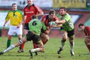 25 January 2009; Tomas O'Leary, Munster, is tackled by Scott Murray and Yannick Caballero, Montauban. Heineken Cup, Pool 1, Round 6, Montauban v Munster, Parc de Sapiac, Montauban, France. Picture credit: Matt Browne / SPORTSFILE