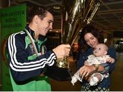 16 August 2015; Ireland's gold medal winner Michael Conlan, Bantam weight, hoists his Best Boxer trophy for daughter Luisne, age 5 months, and Shauna Olali at the Ireland team's homecoming from the EUBC Elite European Boxing Championships. Dublin Airport, Dublin. Picture credit: Cody Glenn / SPORTSFILE
