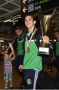 16 August 2015; Ireland's gold medal winner Michael Conlan, Bantam weight, hoists his Best Boxer trophy as he arrives with team-mates including Joe Ward, gold medal winner 81kg light heavy weight, left, with son Joel, age 3, at the Ireland team's homecoming from the EUBC Elite European Boxing Championships. Dublin Airport, Dublin. Picture credit: Cody Glenn / SPORTSFILE