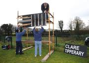 25 January 2009; Groundsmen Pat Rice, Brian O'Neill, left, and Michael Bryan, top, construct the scoreboard before the game. Waterford Crystal Cup Hurling Final, Clare v Tipperary, Ogonnolloe, Co. Clare. Picture credit: Pat Murphy / SPORTSFILE