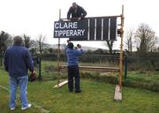 25 January 2009; Groundsmen Pat Rice, Brian O'Neill, left, and Michael Bryan, top, construct the scoreboard before the game. Waterford Crystal Cup Hurling Final, Clare v Tipperary, Ogonnolloe, Co. Clare. Picture credit: Pat Murphy / SPORTSFILE