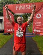 23 August 2015; Peter O'Sullivan, Vodafone,  pictured at the finish line after completing the Vodafone Dublin City Triathlon 2015. Phoenix Park, Dublin. Picture credit: David Maher / SPORTSFILE