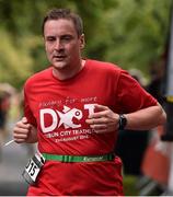 23 August 2015; John Rutherford, Vodafone, pictured at the finish line after completing the Vodafone Dublin City Triathlon 2015. Phoenix Park, Dublin. Picture credit: David Maher / SPORTSFILE