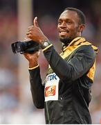 24 August 2015; Usain Bolt of Jamaica uses a video camera at the podium before collecting his Men's 100m gold medal. IAAF World Athletics Championships Beijing 2015 - Day 3, National Stadium, Beijing, China. Picture credit: Stephen McCarthy / SPORTSFILE