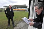 15 February 2009; Programme seller Eamon Flynn reads a programme as Barney Scally, from Rhode, arrives to make a purchase. Allianz National Football League, Division 3, Round 2, Offaly v Longford, O'Connor Park, Tullamore, Co. Offaly. Picture credit: Brian Lawless / SPORTSFILE