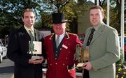 18 October 2000; Kilkenny hurler DJ Carey, left, and Kerry footballer Seamus Moynihan, right, are pictured with their Eircell GAA Player of the Month awards for Ocotber, alonsgside Charlie Lyons, Commissionaire of the Burlington Hotel, at the Burlington Hotel in Dublin. Photo by Ray McManus/Sportsfile