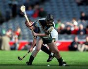 15 October 2000; Fergal McCormack of Ireland in action against Rory Fraser of Scotland during the Hurling Shinty International match between Ireland and Scotland at Croke Park in Dublin. Photo by Brendan Moran/Sportsfile