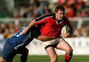 21 October 2000; John Kelly of Munster is tackled by Phil de Galnville of Bath during the Heineken Cup Pool 4 match between Munster and Bath at Thomond Park in Limerick. Photo by Brendan Moran/Sportsfile