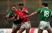22 October 2000; Eoin Fitzgerald of Cork in action against Clement Smith and Jack Foley of Limerick during the Waterford Crystal South East Hurling League match between Limerick and Cork at Gaelic Grounds in Limerick. Photo by Damien Eagers/Sportsfile