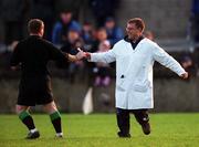 29 October 2000; Referee John Geaney is handed his notebook by an umpire during the Church & General National Football League Division 1A match between Dublin and Tyrone at Parnell Park in Dubln. Photo by Ray McManus/Sportsfile