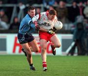 29 October 2000; Cormac McAnallen of Tyrone in action against Darren Homan of Dublin during the Church & General National Football League Division 1A match between Dublin and Tyrone at Parnell Park in Dubln. Photo by Ray McManus/Sportsfile