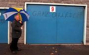 5 November 2000; Steward Jimmy Coppinger stands outside the gates to inform supporters of the cancellation, due to weather, of the Waterford Crystal South East Hurling League match between Tipperary and Cork at Semple Stadium in Thurles, Tipperary. Photo by Damien Eagers/Sportsfile