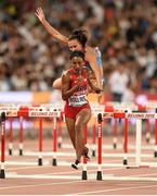 28 August 2015; Brianna Rollins of USA on her way to winning her semi-final of the Women's 100m Hurdles event as Andrea Ivancevic of Croatia takes a fall. IAAF World Athletics Championships Beijing 2015 - Day 7, National Stadium, Beijing, China. Picture credit: Stephen McCarthy / SPORTSFILE