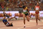 28 August 2015; Danielle Williams of Jamaica crosses the line to win the final of the Women's 100m Hurdle event as Tiffany Porter of Great Britain takes a fall. IAAF World Athletics Championships Beijing 2015 - Day 7, National Stadium, Beijing, China. Picture credit: Stephen McCarthy / SPORTSFILE