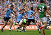 30 August 2015; Colm Boyle, Mayo, is tackled by Dublin players, Tomas Brady, Philip McMahon, Paul Flynn and Jack McCaffrey, resulting in a penalty being awarded by referee Joe McQuillian. GAA Football All-Ireland Senior Championship, Semi-Final, Dublin v Mayo, Croke Park, Dublin. Picture credit: David Maher / SPORTSFILE