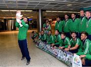 30 August 2015: Ireland physio Stephen Haslam and his daughter Cara, 7 weeks old, celebrate infront of the team. The Irish Hockey team arrived home into Dublin Airport with a Bronze medal after defeating England in the Eurohockey Championships in London, England. Dublin Airport, Dublin. Picture credit: Ray Lohan / SPORTSFILE