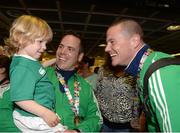 30 August 2015: Nathan, age 2, and his dad Stephen Barry, strength and conditioning coach, with Johnny Caren, assistant coach. The Irish Hockey team arrive home into Dublin Airport with a Bronze medal after defeating England in the Eurohockey Championships in London, England. Dublin Airport, Dublin. Picture credit: Ray Lohan / SPORTSFILE