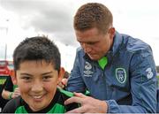 1 September 2015; James McCarthy, Republic of Ireland, gives autographs to participants during the FAI Golden Camp, a summer camp run by the FAI for season ticket holders who participated in the Sports World Summer Soccer Schools Programme. Abbotstown, Co. Dublin.. Picture credit: Sam Barnes / SPORTSFILE
