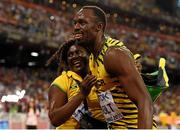 23 August 2015; Usain Bolt of Jamaica celebrates with his mother Jennifer after winning the final of the Men's 100m event. IAAF World Athletics Championships Beijing 2015 - Day 2, National Stadium, Beijing, China. Picture credit: Stephen McCarthy / SPORTSFILE